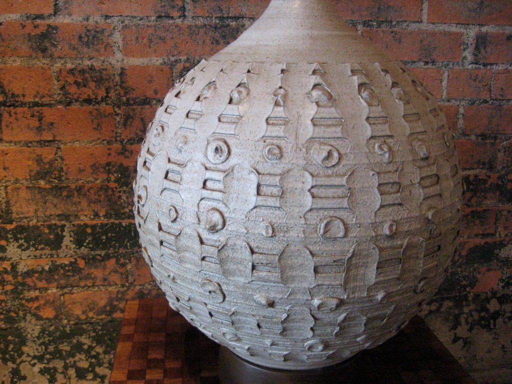 A large studio pottery lamp on walnut base signed 