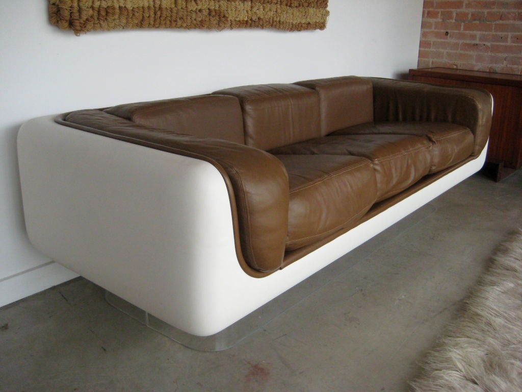 Fiberglass sofa with lucite base and original leather designed by Warren Platner for Steelcase. Pair of matching club chairs and side tables also available.