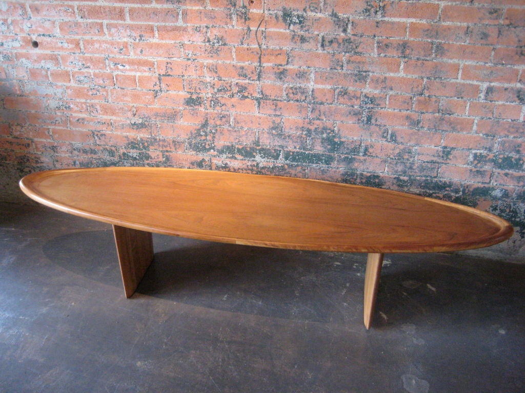 A rare walnut surfboard coffee table designed by T.H. Robsjohn-Gibbings for Widdicomb.