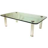Glass coffee table with lucite legs