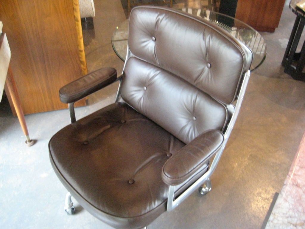 Brown leather desk chair designed by Charles Eames for the Time Life building. Very nice patina to arms. If you prefer the arms to be restored, this would be included in the price.
