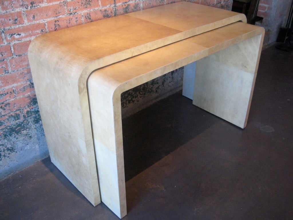 Pair of stunning console tables completely covered in parchment that nest together.