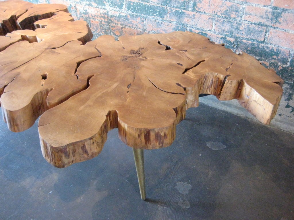A beautiful free edge cyprus slab coffee table with brass legs inspired by Nakashima.