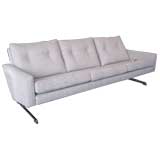 Cantilevered sofa with chromed base and rosewood feet