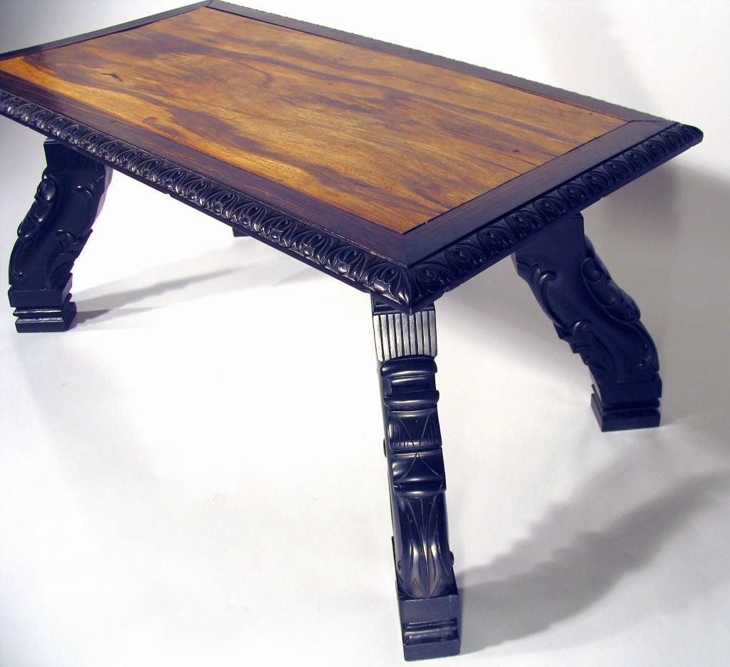 Ceylon; circa 1880-1900. A rectangular top with leaf-tip carved edge raised on thick, heavily carved scrolled legs.