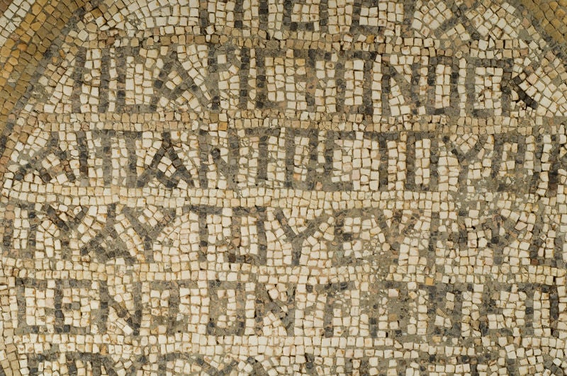 Stone tesserae with eight lines of inscription in Greek:  