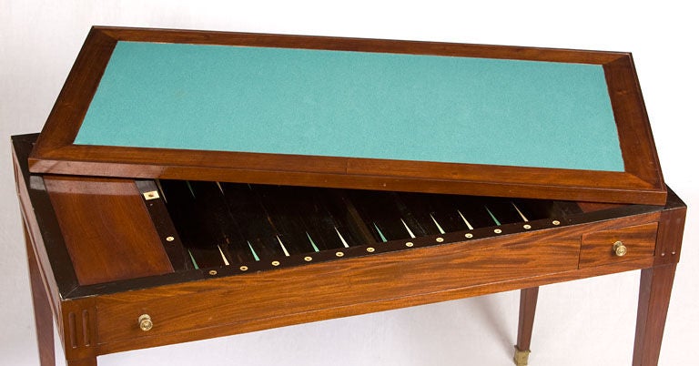 Directoire mahogany Tric-Trac table. A versatile table used for <br />
backgammon,the reversable top with the leather side up for writing<br />
the other side for card games.
