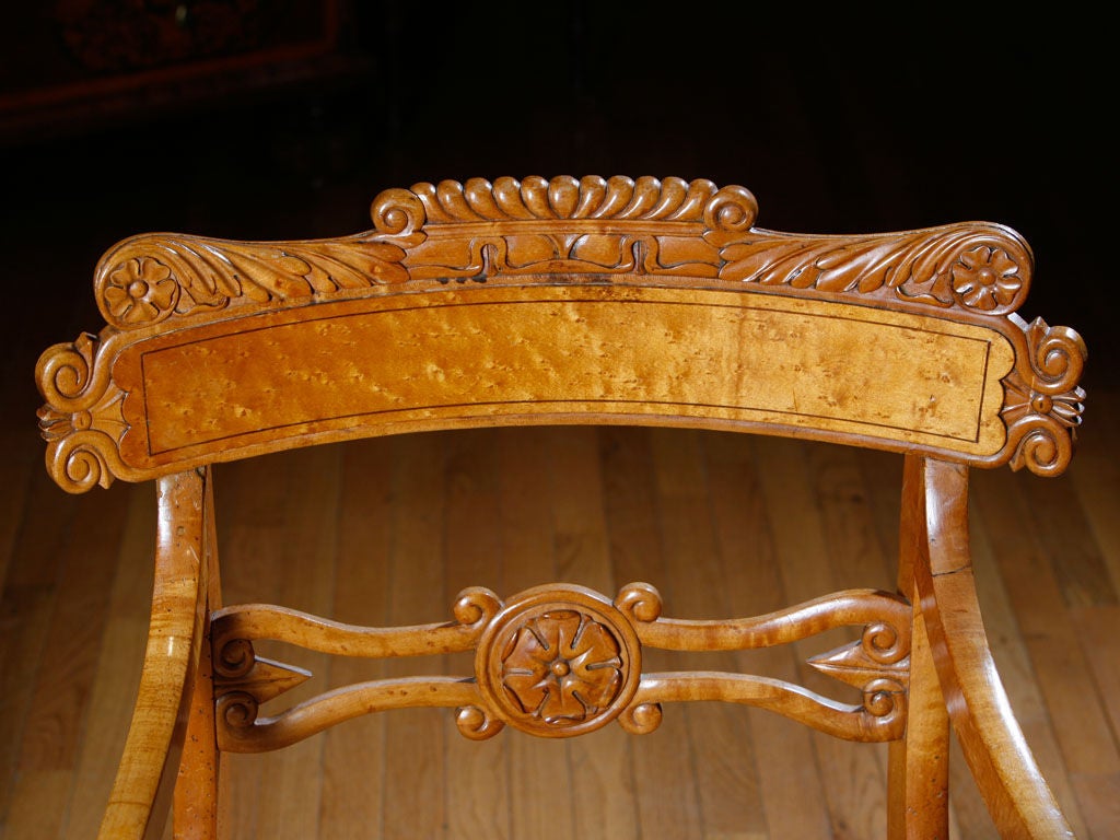 Set of eight Russian Karelian birch dining chairs, two-arm 

and six sides. The crests and backs carved with classical motifs,

the turned legs with ebony line inlay.