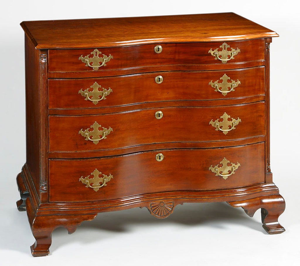 Connecticut Cherry Chippendale reverse serpentine chest with fluted quarter columns, shaped bracket feet and a central fan carved pendant.