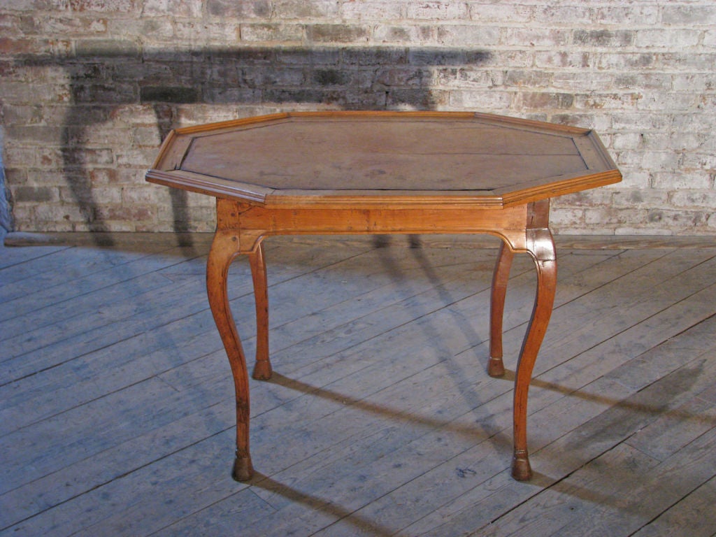 Elegant and charming Italian octagonal small Center or Occasional Table, The leather inset octagonal molded top above four cabriole legs.
Wonderful light colored fruit wood with a lush patina, Solid, pegged construction.
