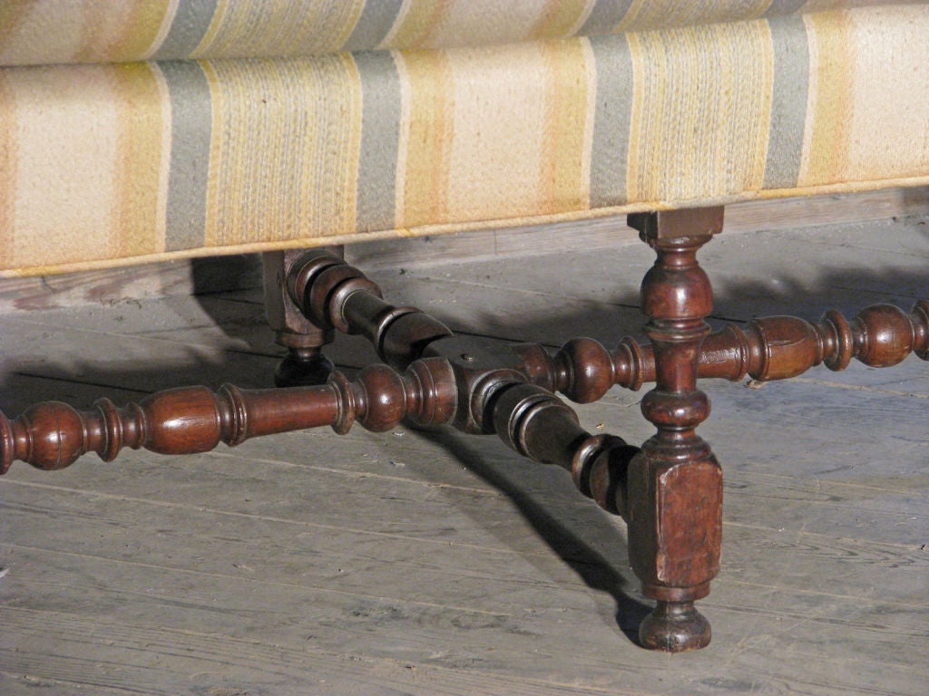 Petit and delicate settee with straight simple lines, nicely turned walnut legs joined by similar turned double H-stretcher, to be reupholstered.
