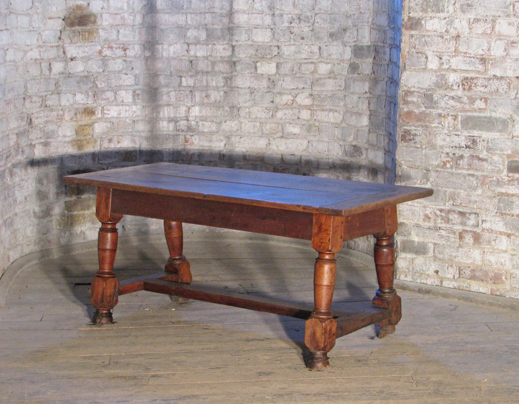 Low table, coffee table/occasional/end table,  bold appearance with sturdy turned legs joined by H-stretcher.
