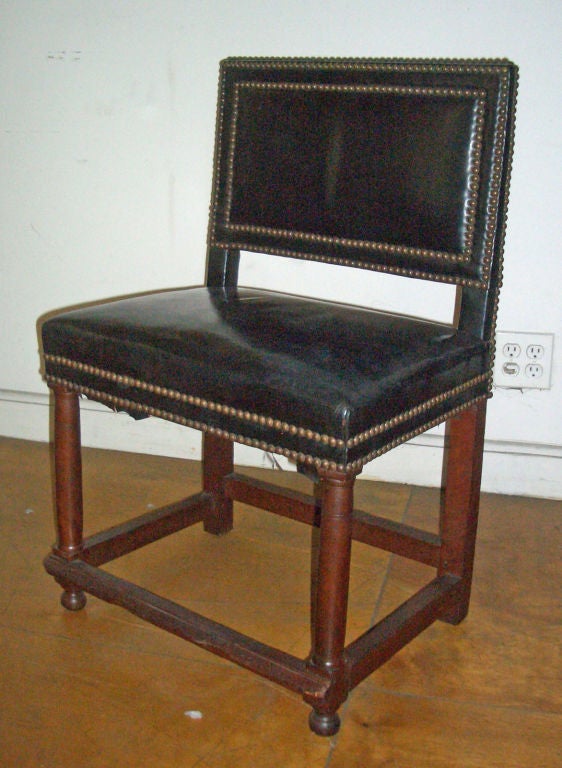 Rare set of four Henry II side chairs, beautiful simple lines, upholstered in black leather.
