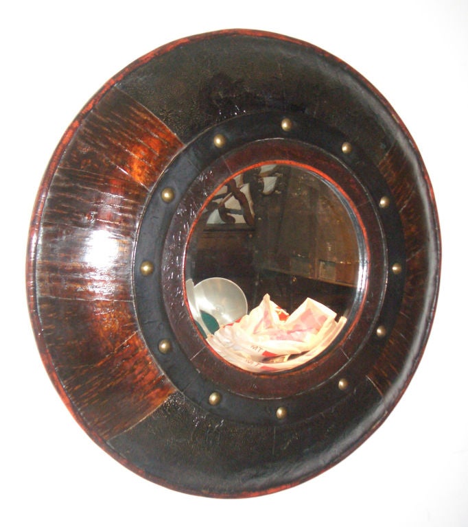 Unusual pair of round mirrors, the massive frame, made from an interesting mix of materials (palm wood, brass, leather), containing beveled mirror plates.
