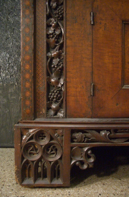 Very attractive, rare and large Gothic cabinet / sideboard with three drawers over two doors, constructed in three parts.
beautiful Gothic tracery work, boldly carved grapevines and decorated with strips of intricate geometric inlay. Basically pine,