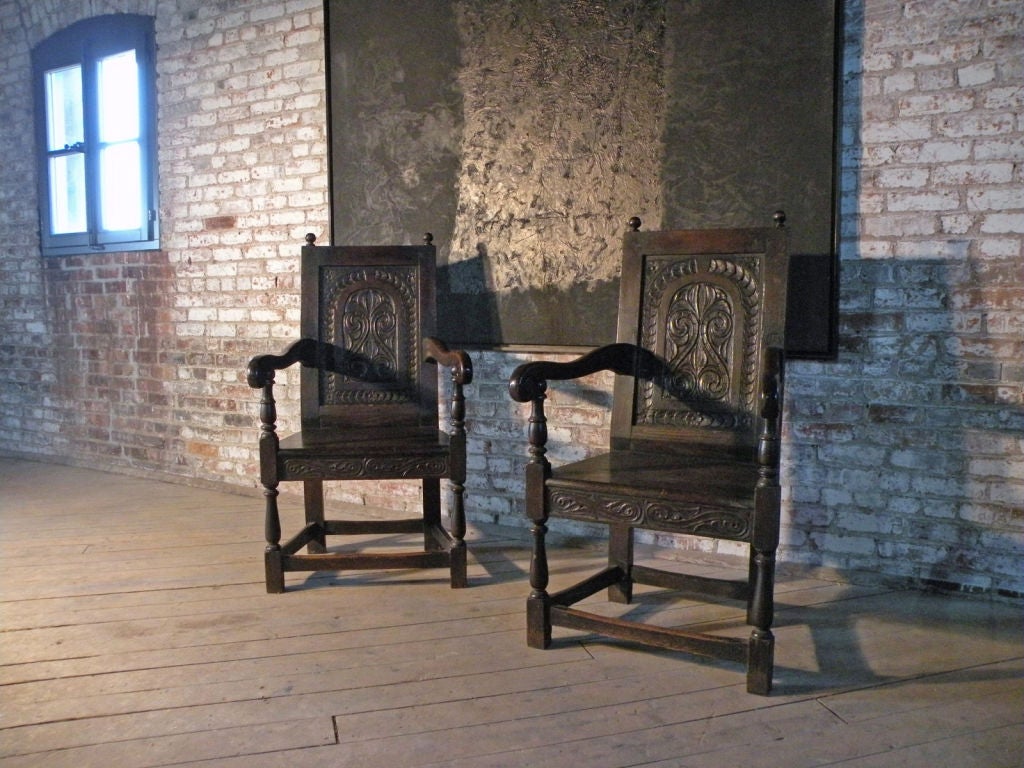 Nice pair of Wainscot chairs of typical form, with carved back panels and front rail, turned legs.