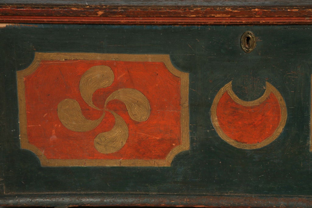 This chest is distinctive to the Mohawk River Valley of New York, with its trestle type shoe feet and bold pinwheel and moon decorations. This example has superb proportions and remains in outstanding condition. It is a beautiful piece of high