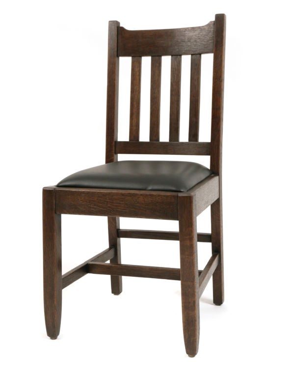 Solid quarter sawn oak highly grained Mission dining chairs circa mid 1920's. These chairs are done in the tradition of the finest furniture companies of their day like Stickley and Limbert and are a rare complete set of 6. Unmarked new black