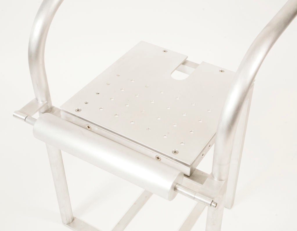 Early prototype sculpted aluminum chair by architect and designer Robert Whitton, circa 1989. Features a perforated aluminum seat with a rolling bar that moves for ease of entry into the chair. The swooping curved arms provide an incredible contrast