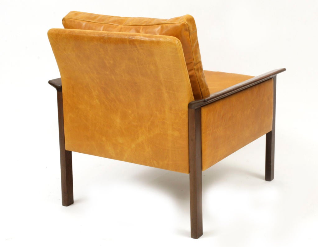 Beautiful pair of brazilian rosewood and leather lounge chairs designed by Hans Olsen circa early 1960's. Feature flared rosewood arms down filled back cushions and exquisite caramel colored Edelman leather upholstery. Accompanying sofa also