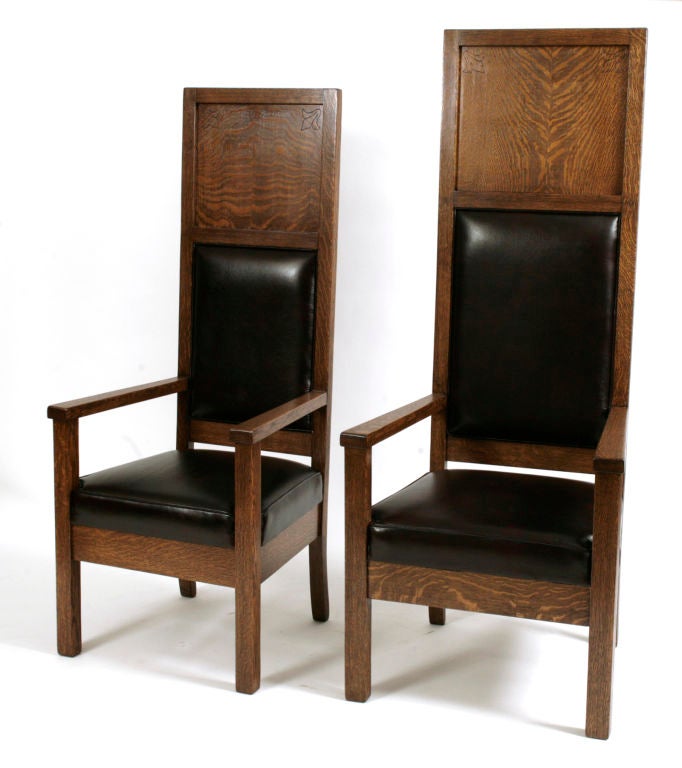 Phenomenal set of eight solid quarter sawn oak chairs from a Masonic Lodge circa early 1930’s. These chairs are nearly 6 feet tall and feature incredible wood graining on the fronts and backs

leaf motifs in the upper corners and new supple maroon