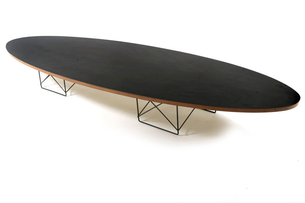 Charles and Ray Eames for Herman Miller ETR surfboard table circa 1951. This table was purchased from a former employee of Herman Miller who worked with Charles and Ray in the Herman Miler office. Features rare black top with exposed plywood sides.
