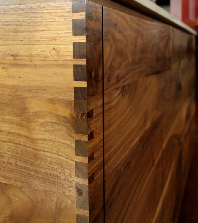 Exquisitely crafted solid walnut sideboard designed by Daniel Germani for Brett Smith woodworks. Chest is constructed of solid american walnut and features hand carved handles with inlaid spalted maple detailing. The interior drawers are also solid