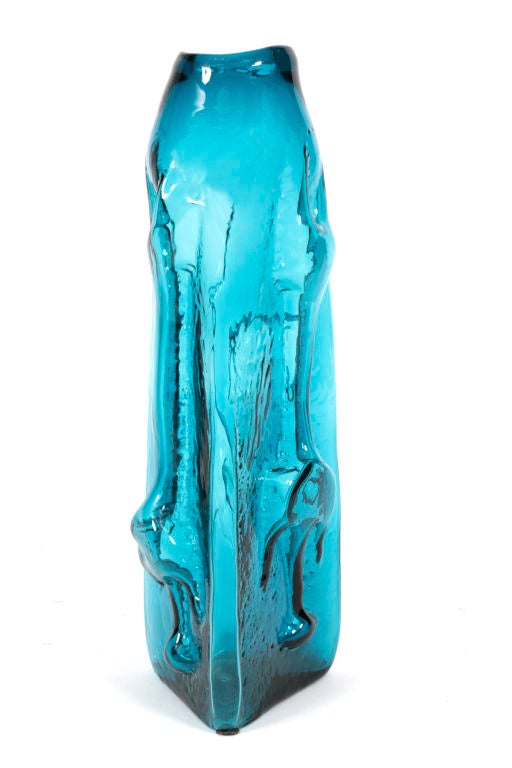 Monumental hand blown glass vase by Blenko circa early 1960's. Features 3 dimensional sculpted forms on all three sides and incredible deep blue color.