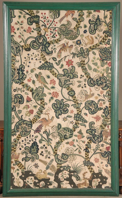 A large pair of crewel work panels depicting the tree of life populated with fanciful representations of parrots, peacocks, squirrels, leopards and deer. Now framed behind UV protective plexiglass.