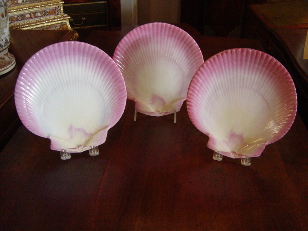 A set of eight pink enamel decorated Wedgwood earthenware shell for plates. Seven bearing the upper case WEDGWOOD<br />
mark with the date letter code WXG, one slightly earlier with  impresse 
