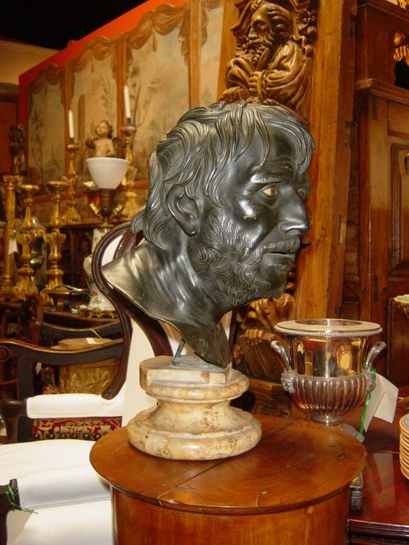 A bronze bust of the Roman statesman Senneca after the classical original, probably cast in Naples as a Grand Tour<br />
souvenier. With original painted detail to the eyes, open mouth<br />
and mounted on its original marble base.