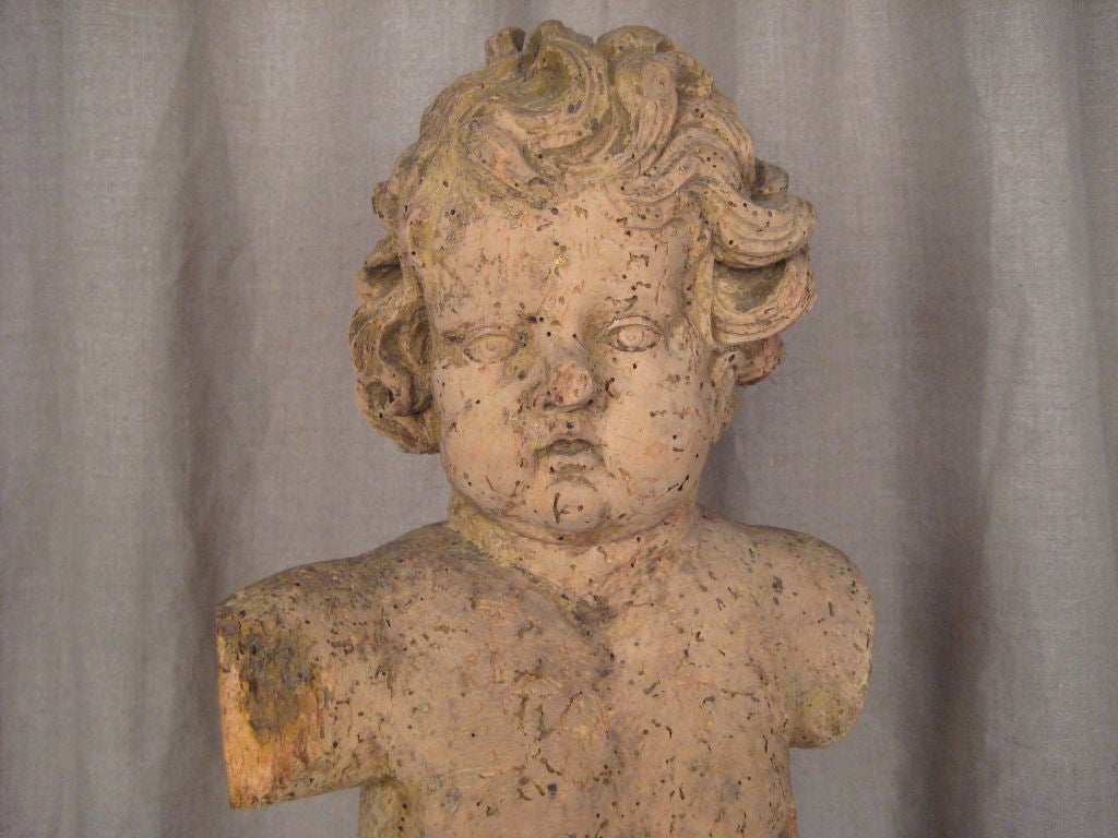 18th c., hand-carved wood statue of a cherub mounted on a custom, Lucite base.