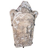 Architectural Fragment of a Stylized Head in Stone