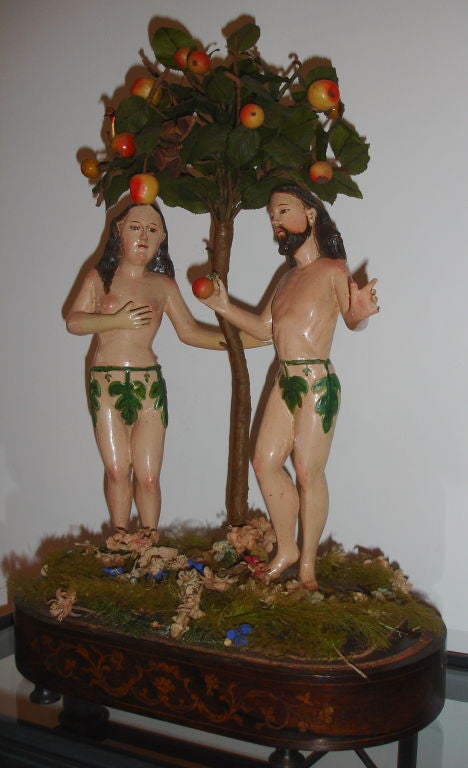 Adam and Eve in Paradise next to the tree of good and evil surrounded by fruit, birds and insects.  The figures are 18th century; the base, tree and fruits later.  Provenance: Bullrich, Arte y Antiguedades, Buenos Aires, 1976; Private Collection