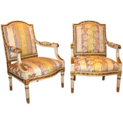A pair of painted wood armchairs