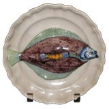 Tin glazed earthenware dish mounted with fish