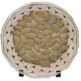 Tin glazed earthenware dish mounted with almonds