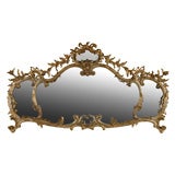 Carved and gilded wood caminiera mirror.