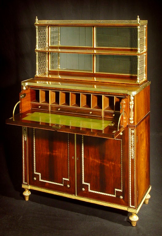 attributed to John McLean; executed in the most vibrant veneer throughout; the two tier mirror-backed superstructure supported by brass columns and surmounted by a three-quarter pierced brass gallery and urn-form finials; the projecting lower part