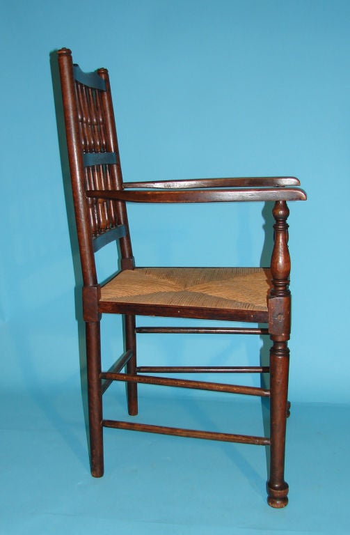 An assembled set of 8 English ash spindle back chairs with turned legs ending in pad feet each with rush seats consisting of 6 side and 2 arm chairs. Circa 1880 and later.
