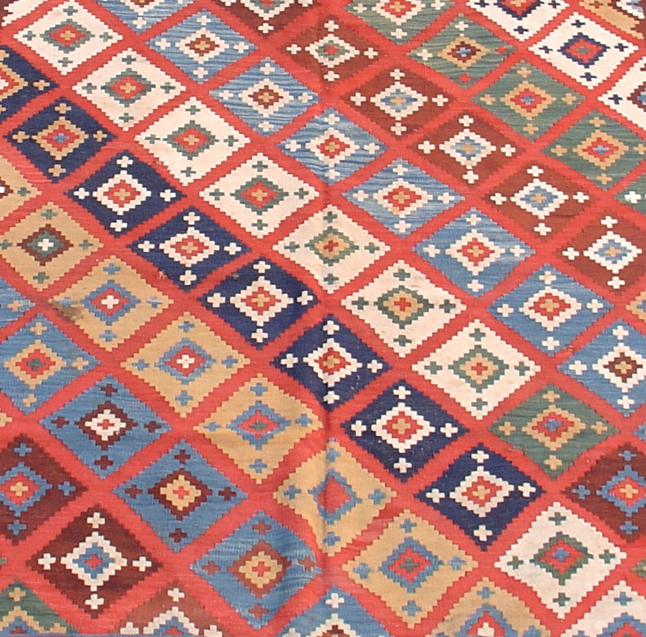 A lovely autumn toned Kilim with a diagonally geometric lattice design and traditional 'checkerboard' ends.