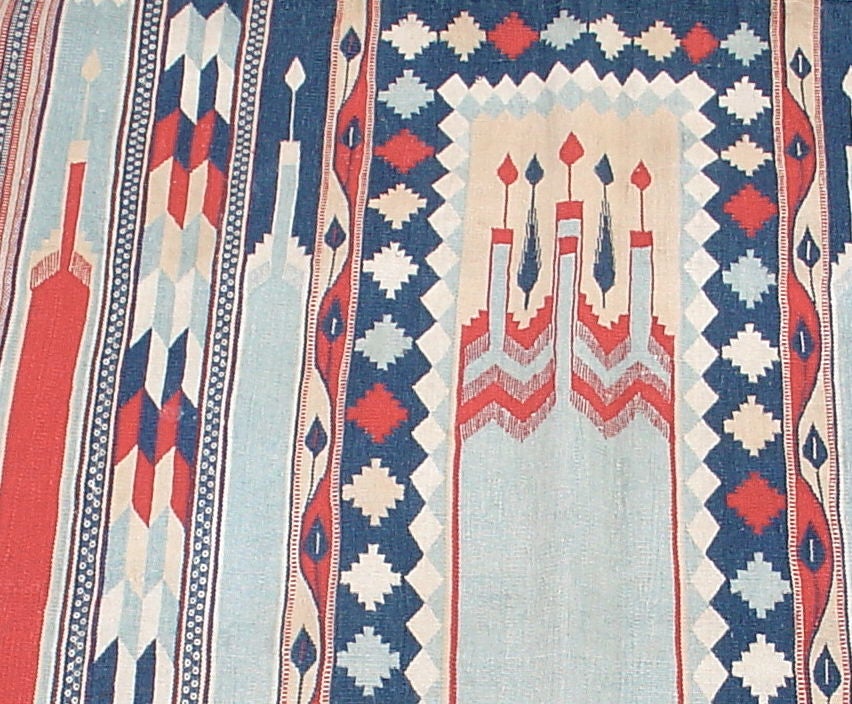 A charming, small, cotton Dhurrie prayer rug with a prayer design in shades of soft blue, navy, cream, red and ivory.