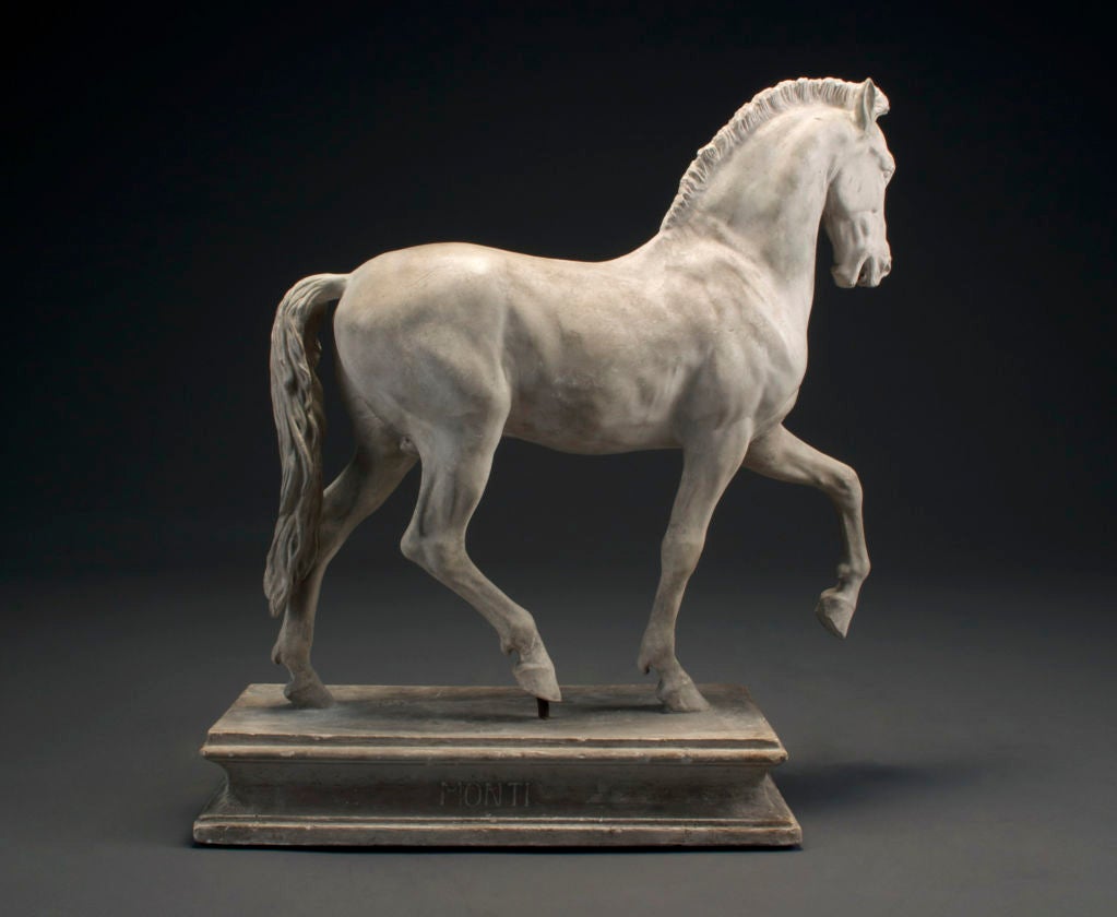 Modeled, head aloft, in a walking pose, with a braided mane and flowing tail, on a rectangular molded edge plinth with concave sides.<br />
Raffaelle Monti (1818 - 1881), the son of the Milanese sculptor Gaetano Matteo Monti, studied in Vienna and