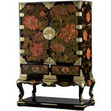 A Japanese Gilt Metal Mounted Polychrome Lacquer Cabinet