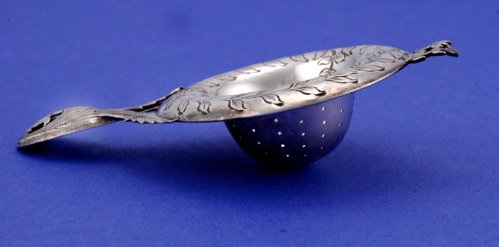PLEASE VISIT LAUREN STANLEY IN NEW YORK <br />
<br />
Rare circa 1900 sterling silver tea strainer designed by F. Walter Lawrence for Lebkuecher of Newark, N.J., with flat chasing, engraving and bright cut work in a rococo motif, the bowl finely