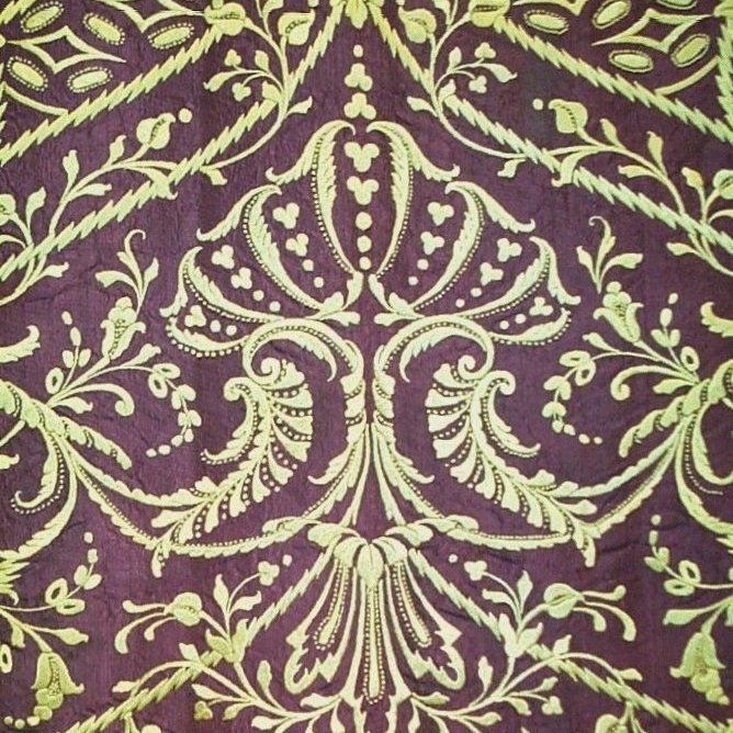 A pair of 18th century Italian panels embroidered in yellow silk threads in an ornate decorative pattern on a purple silk faille ground. Panels joined to make a table cover.