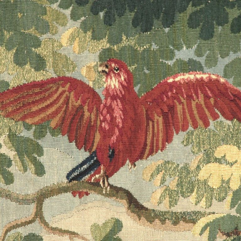 A very fine pair of Antwerp verdure tapestry panels with a cardinal and a parrot depicted in reds and yellows. The trees are beautifully depicted with the use of mixed yarn in areas.