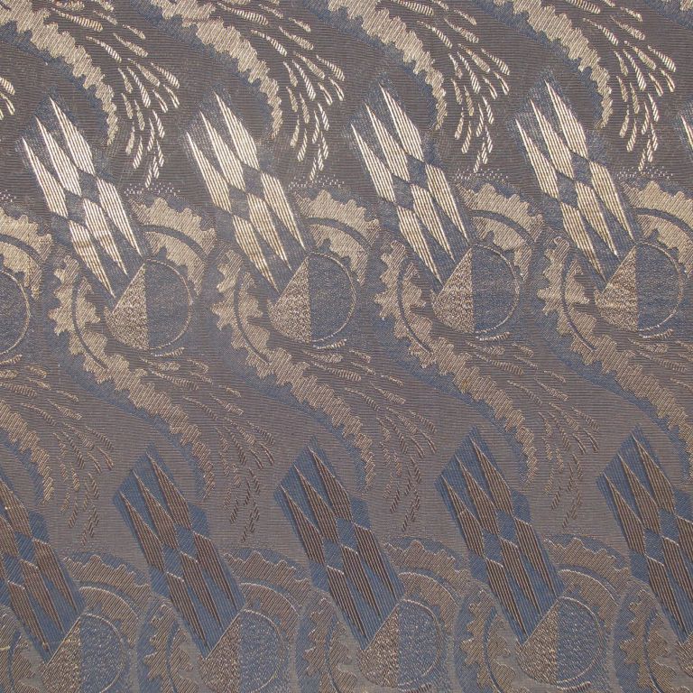 French Art Deco rayon furnishing fabric with a blue ground with a repeated patterned in silver depicting half moons framed with a fern fronds and sprays at the top with a stylized triple wings motif.
