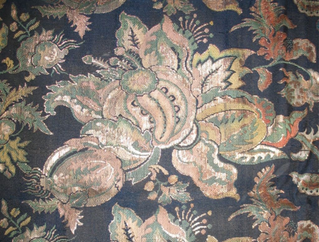 A late 18th century Japanese silk brocade with a navy blue ground brocaded in patterns of flowers and gourds highlighted with gold metallic thread.