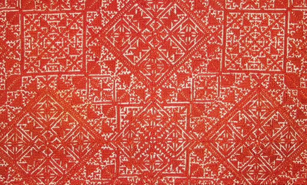 c. 1890 Fez, Morocco embroidered cover on an off white cotton embroidered in a counted stitch done in brick colored red cotton thread in geometric patterns that completely fill the ground.  This type of domestic embroidery is known only to be made